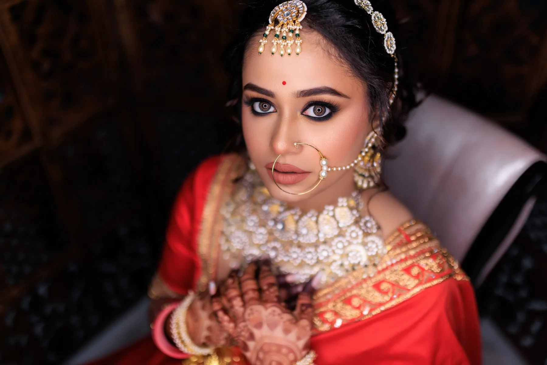 Bridal makeup in Bhubaneswar by Romma — bride in red saree with traditional jewellery