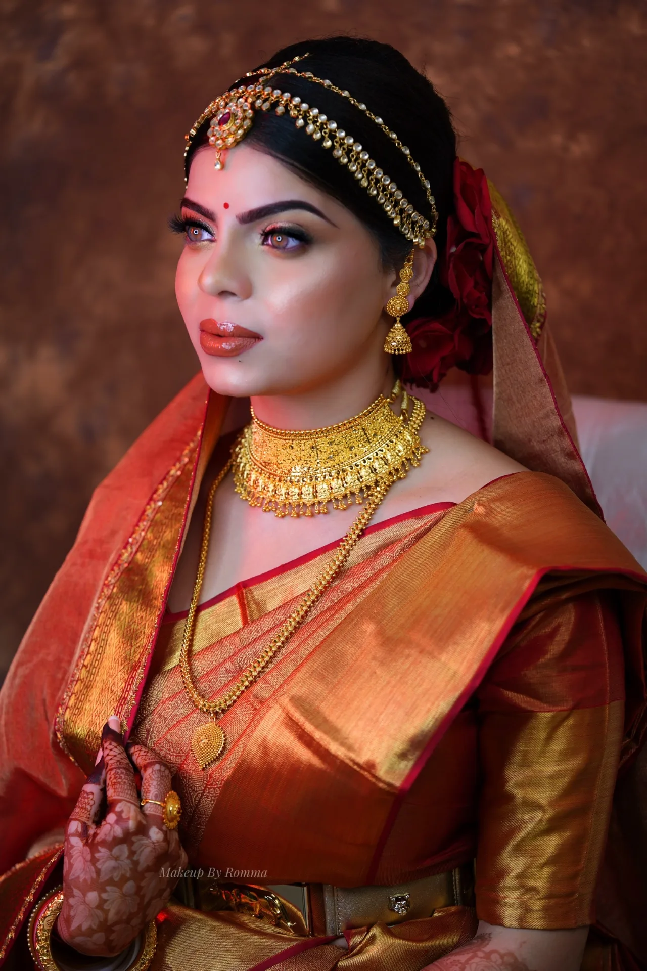 Wedding makeup in Cuttack by Romma — bride in gold and red silk saree