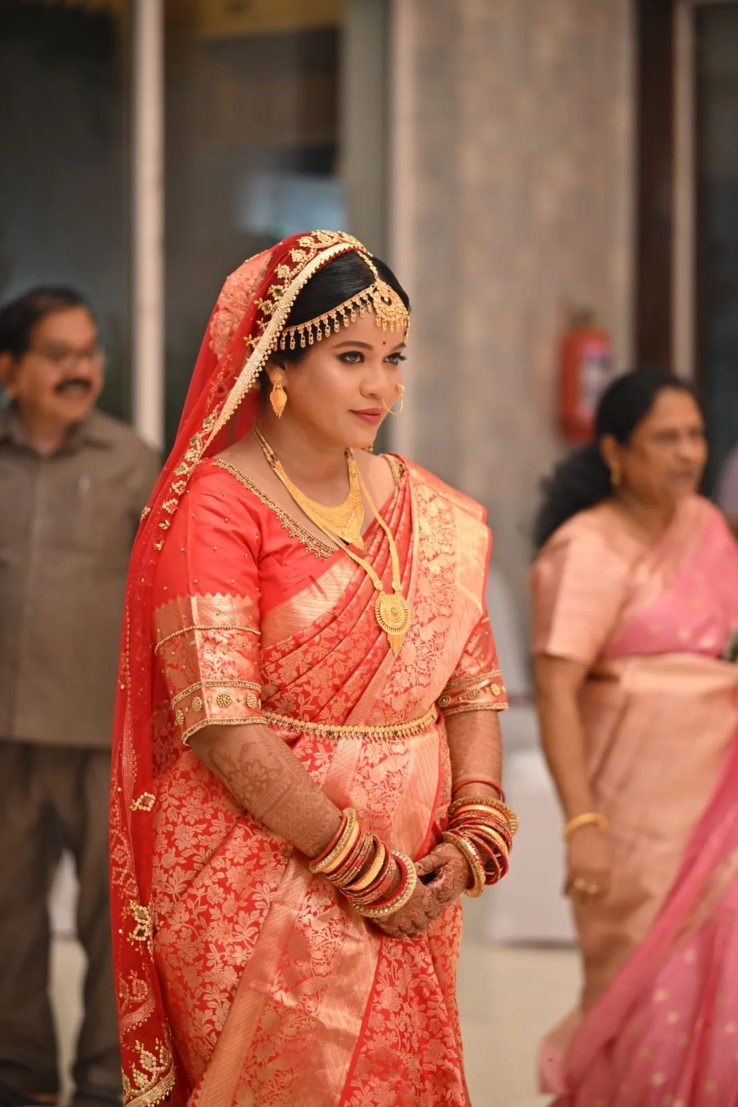 Dr Arti in profile in her red and gold Kanjeevaram silk saree on her wedding day — bridal makeup by Romma, Odisha