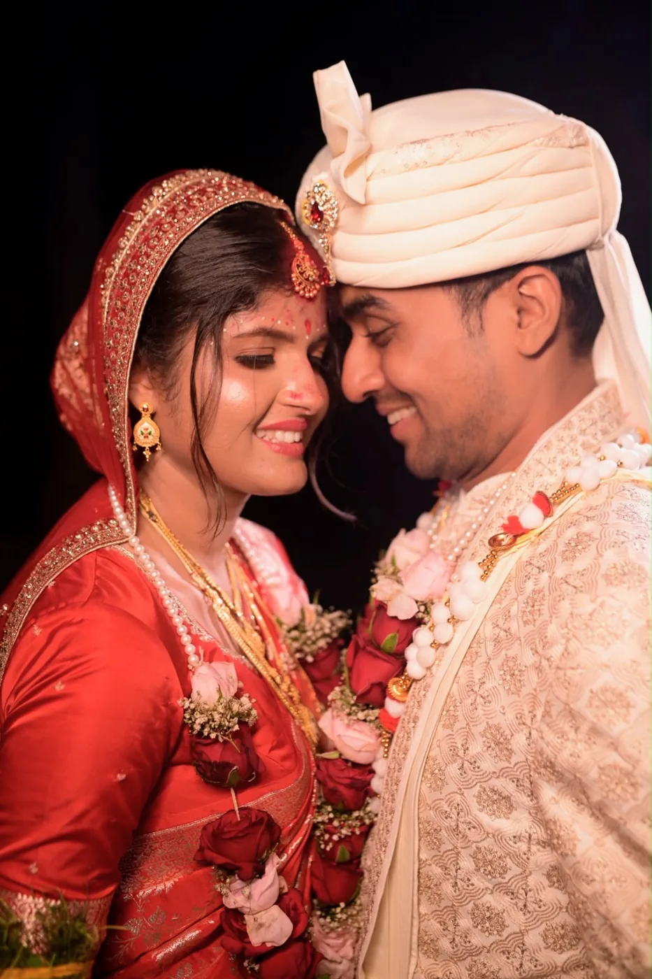 Pratyasha in red Banarasi silk with her groom — bridal makeup in Bhubaneswar by Romma
