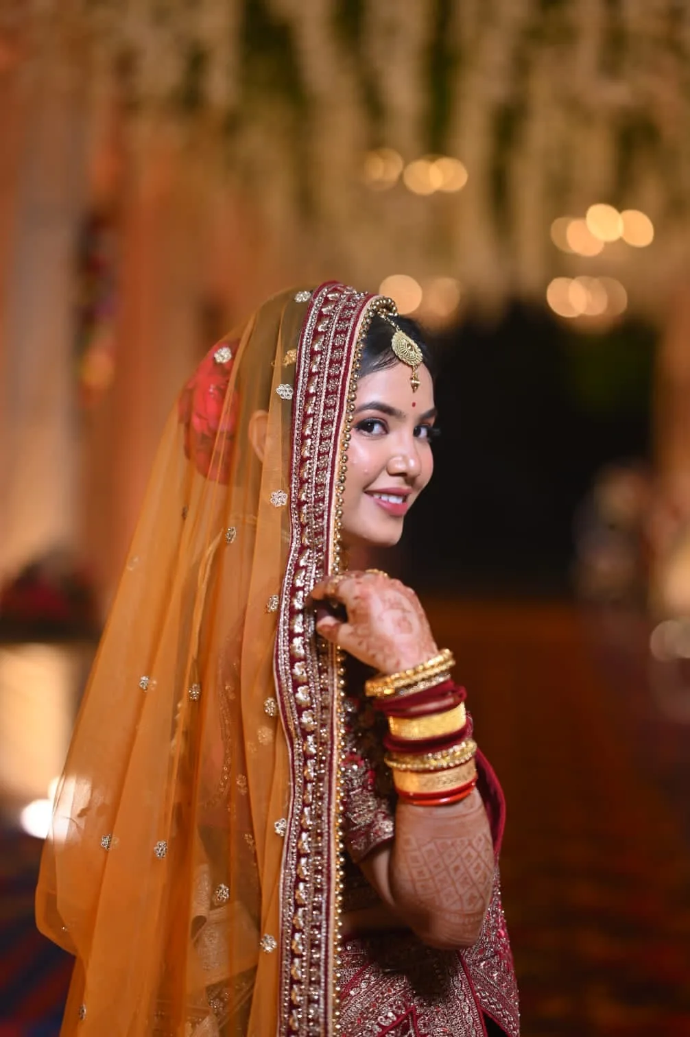 Priyadarsini — bride by Romma in Cuttack, glancing back beneath her dupatta